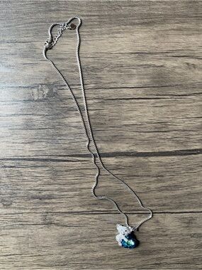 Koala Bear Hugging Sapphire Blue Heart Pendant Necklace with silver earrings.